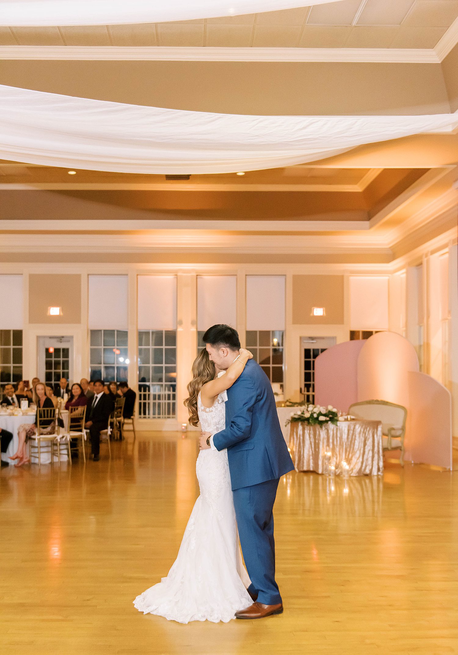 bride and groom hug during first dance at Higgins Hall