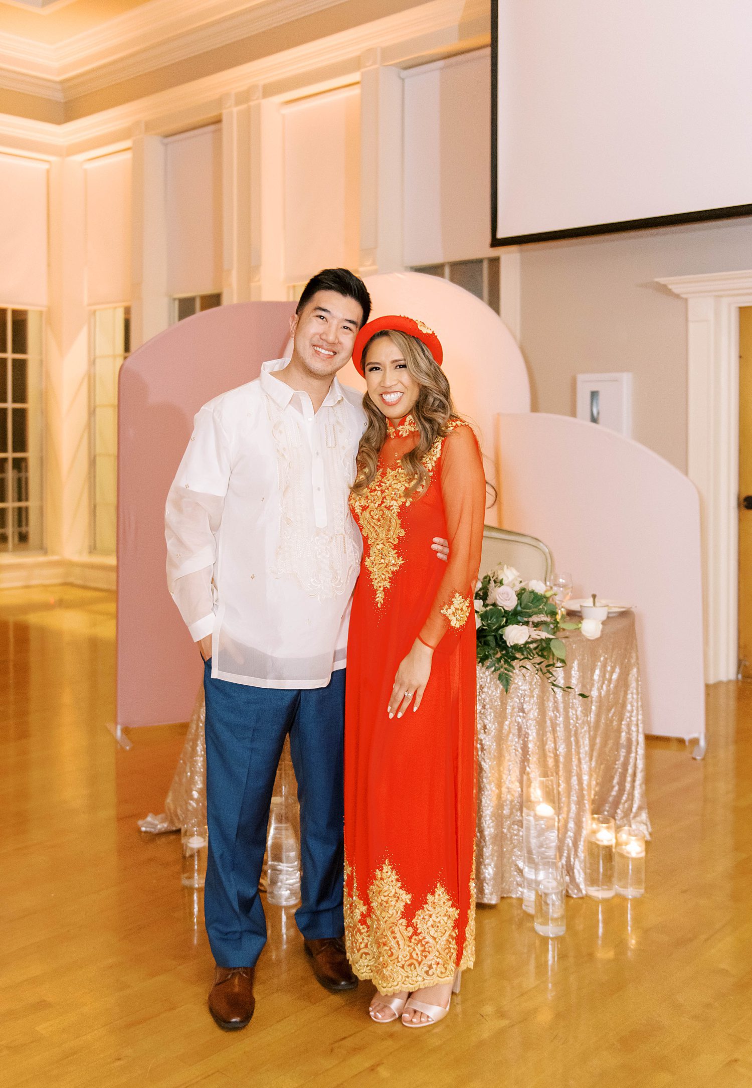 bride and groom pose in traditional Chinese wedding attire at Higgins Hall