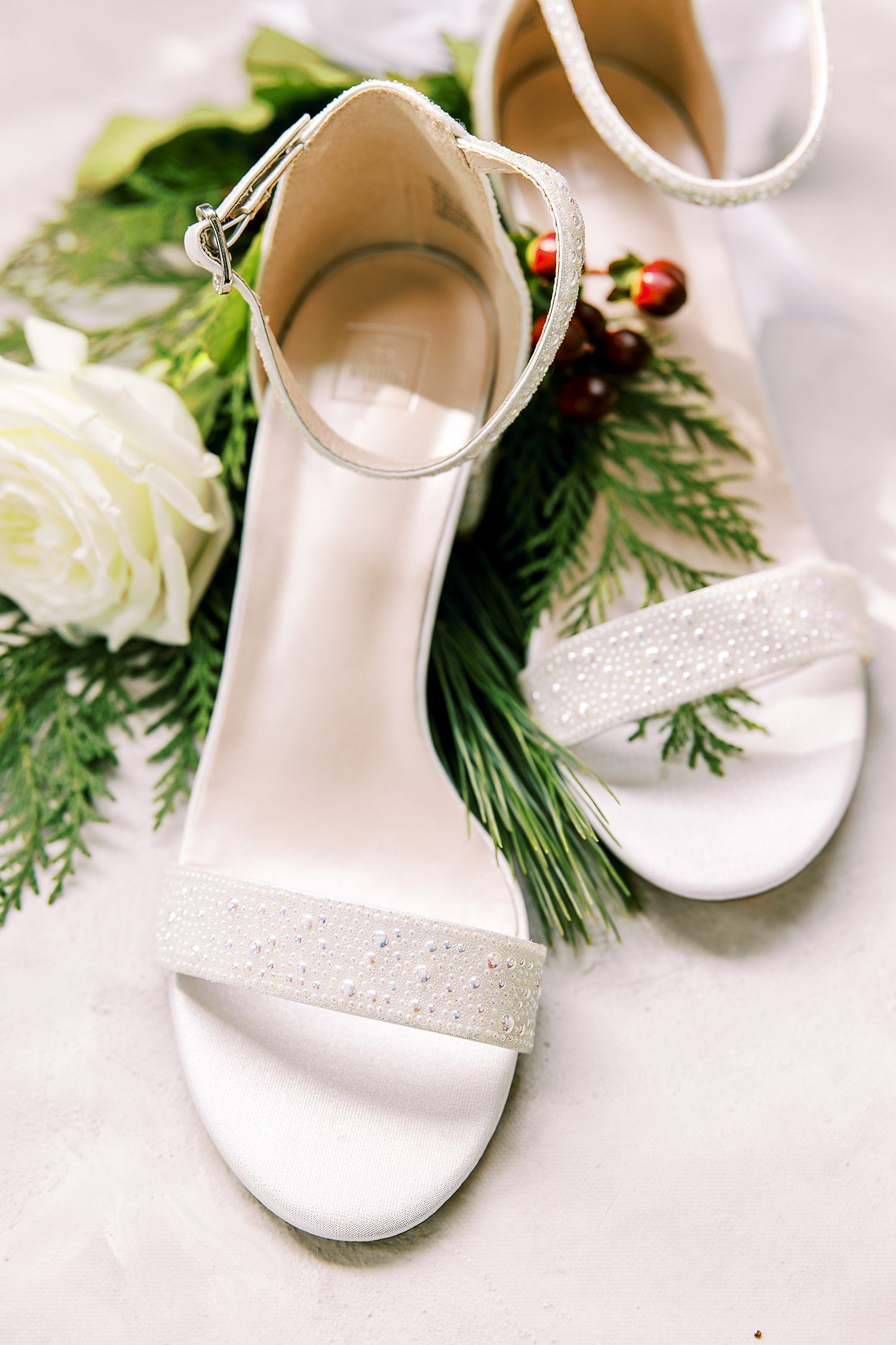 bride's Ivory shoes with greenery and berries 