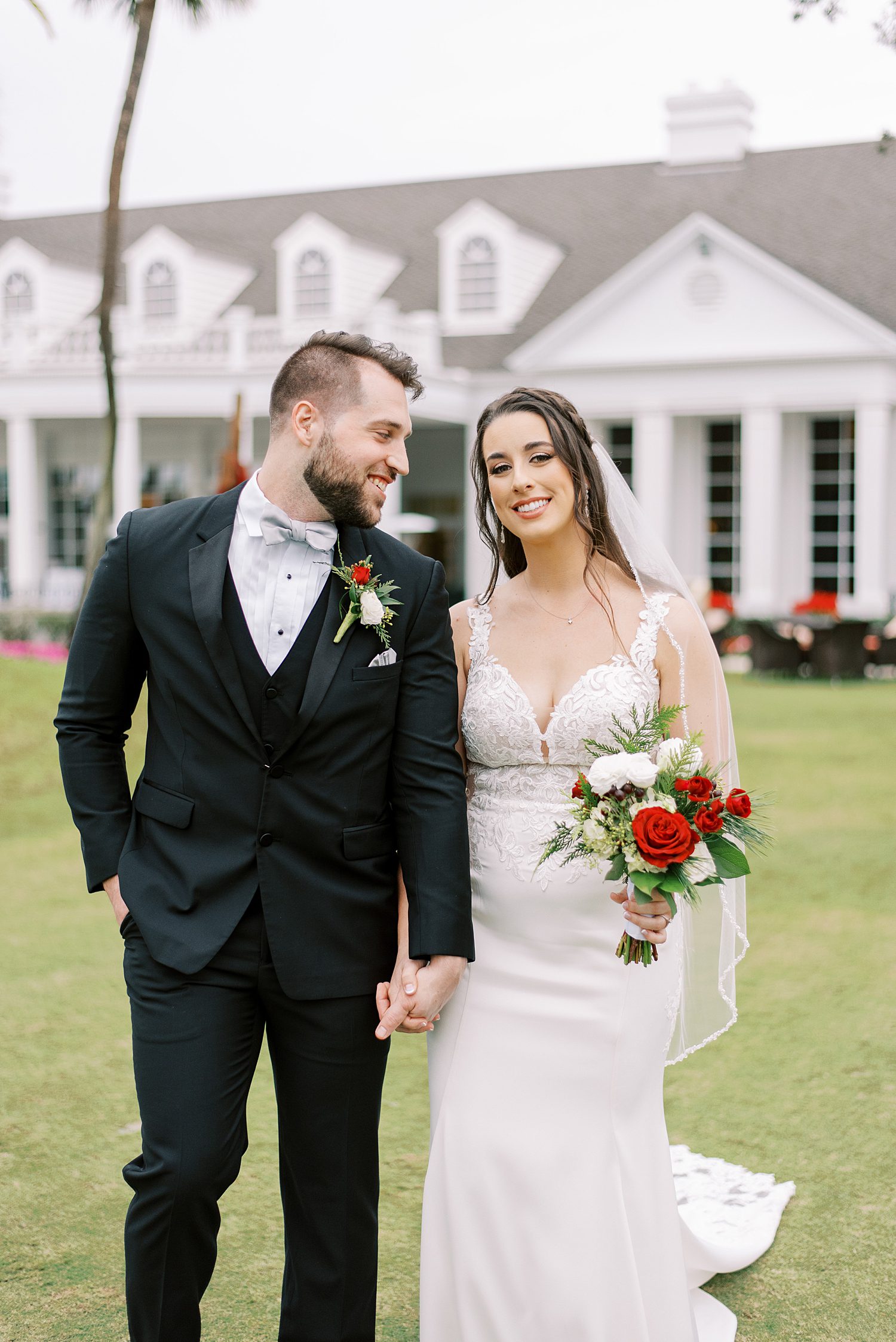 bride and groom hold hands walking on lawn at Palma Ceia Country Club