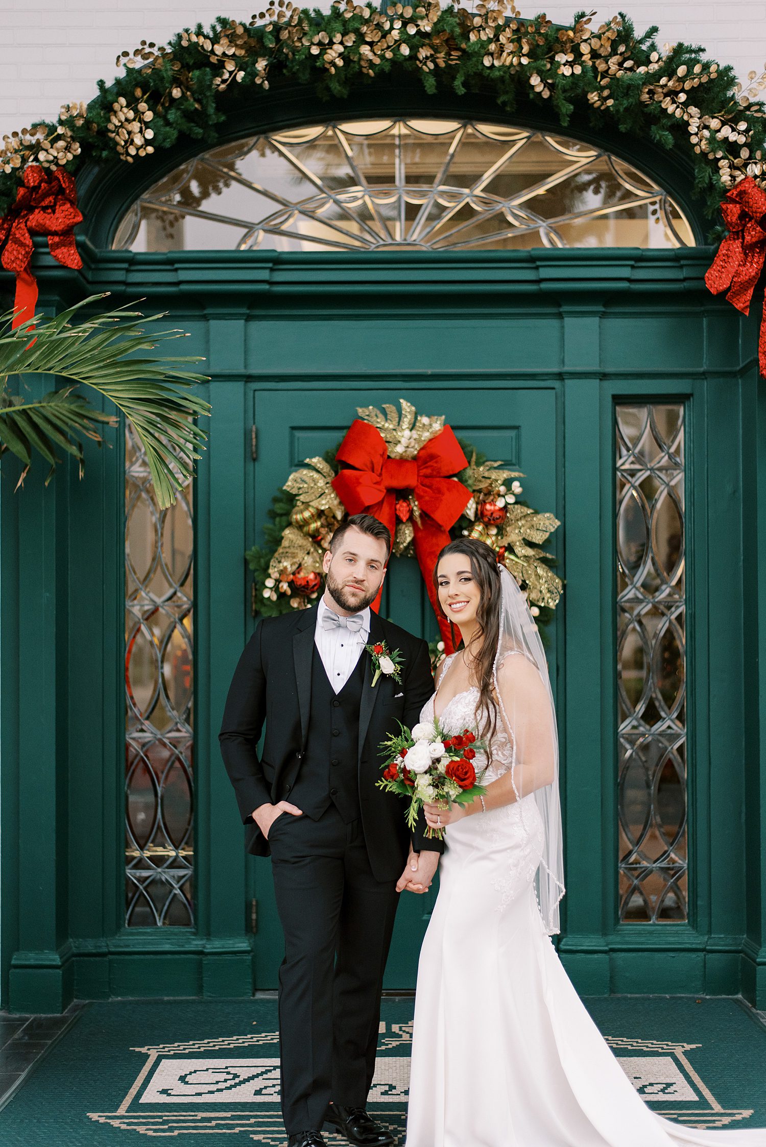 bride and groom pose by teal door at Palma Ceia Country Club
