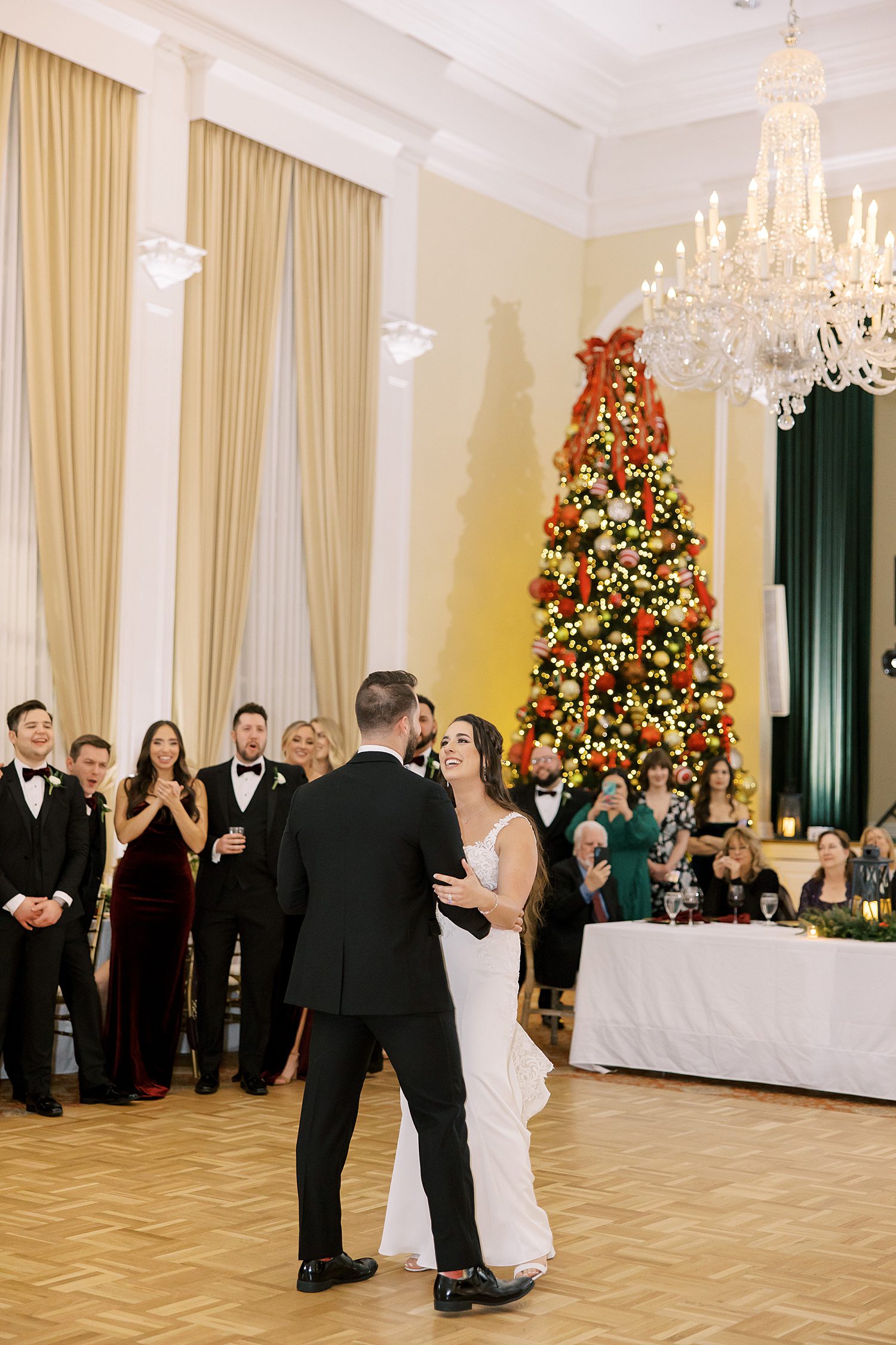 bride and groom have first dance during Christmas inspired wedding reception 