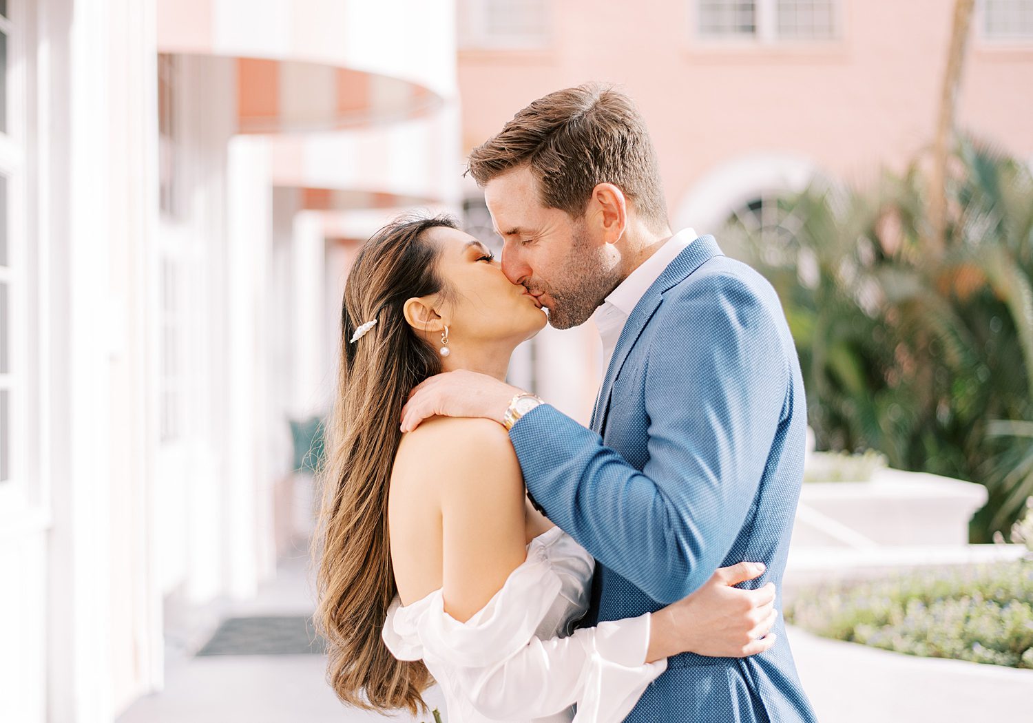 engaged couple kisses outside hotel during St. Pete Beach engagement session