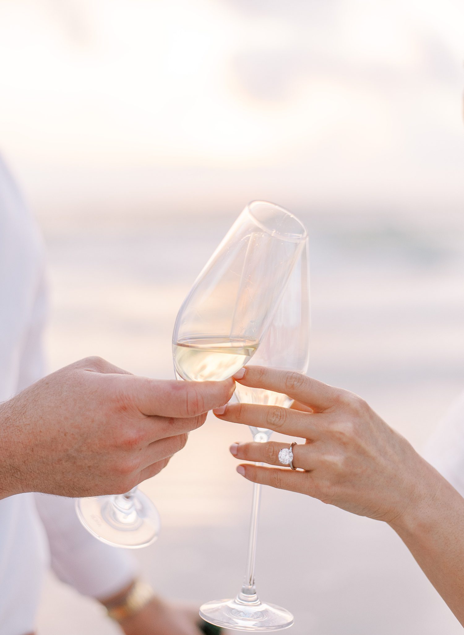 couple toasts glasses of Champagne on St. Pete Beach