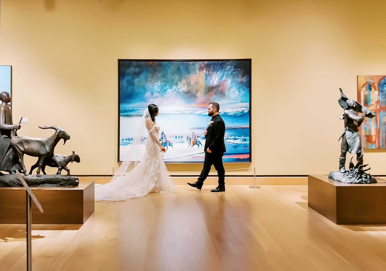 bride and groom walk to meet for first look in gallery at The James Museum