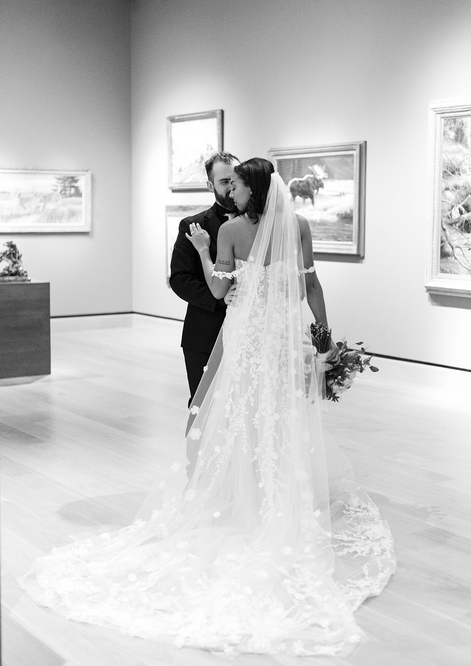 bride and groom hug in gallery of The James Museum