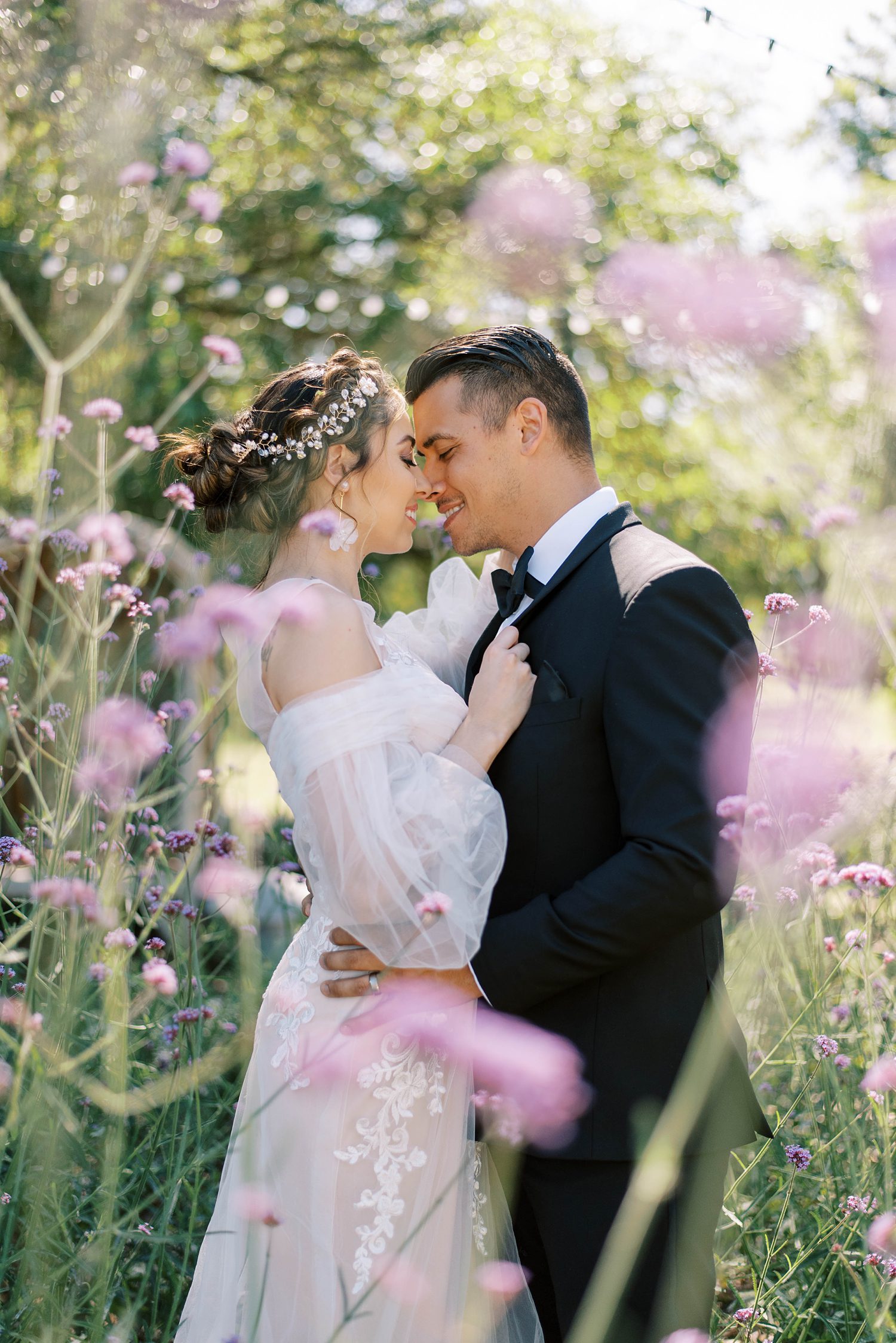 bride and groom hug among purple flowers