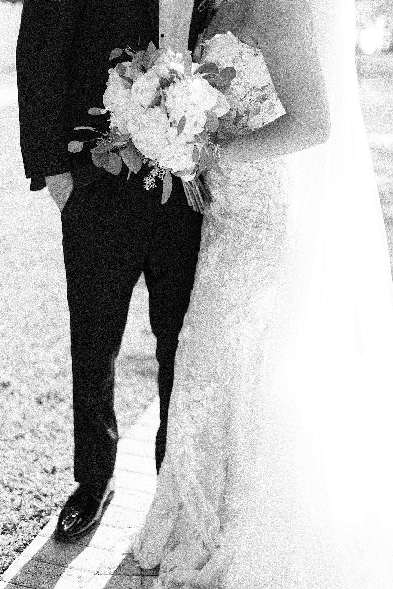 black and white photo of bride and groom hugging together