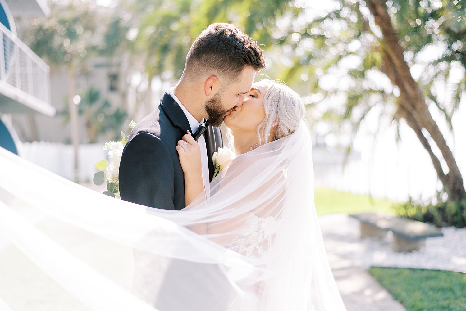 newlyweds kiss with bride's veil wrapped around them at The Godfrey