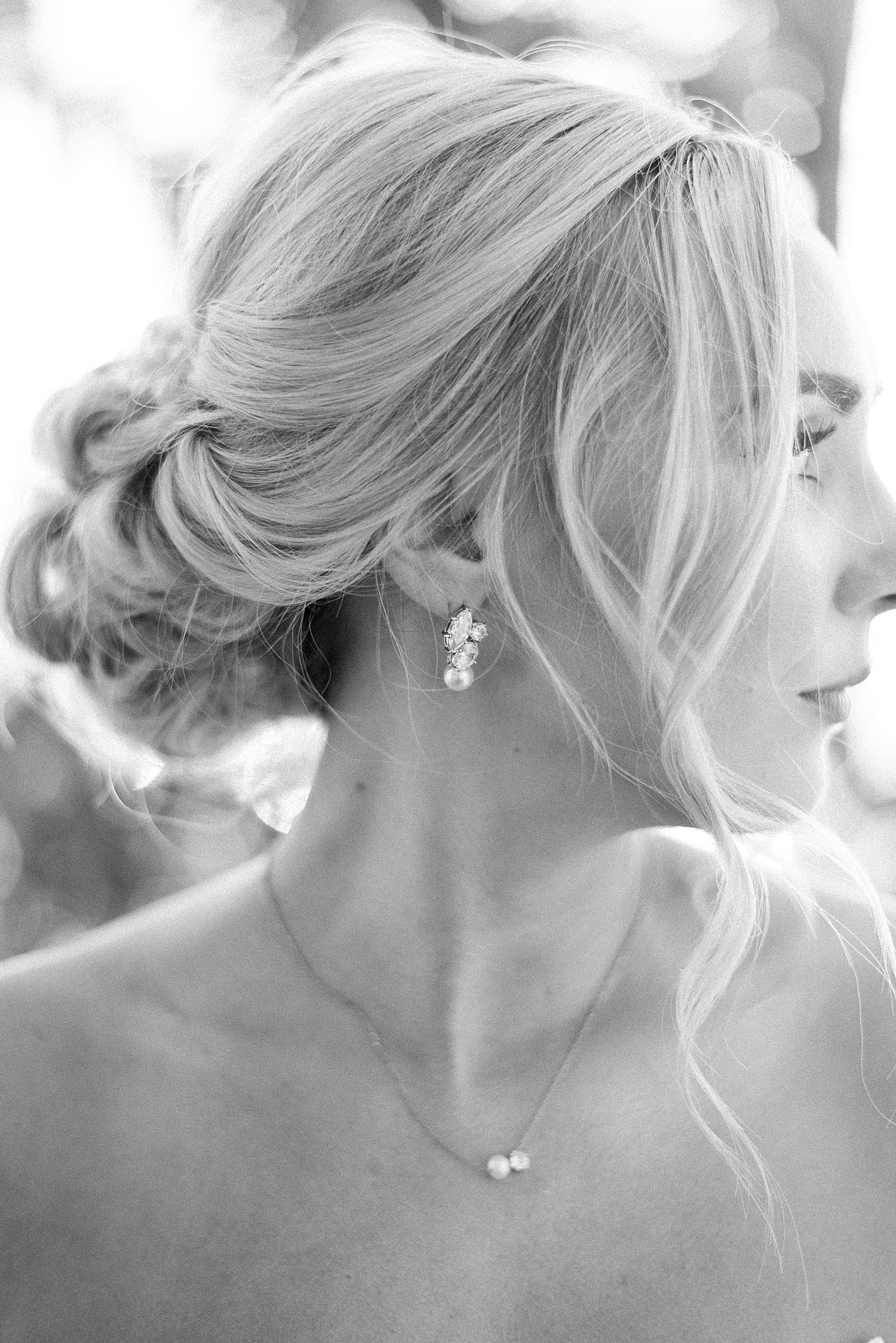 black and white photo of bride looking over shoulder in strapless wedding gown