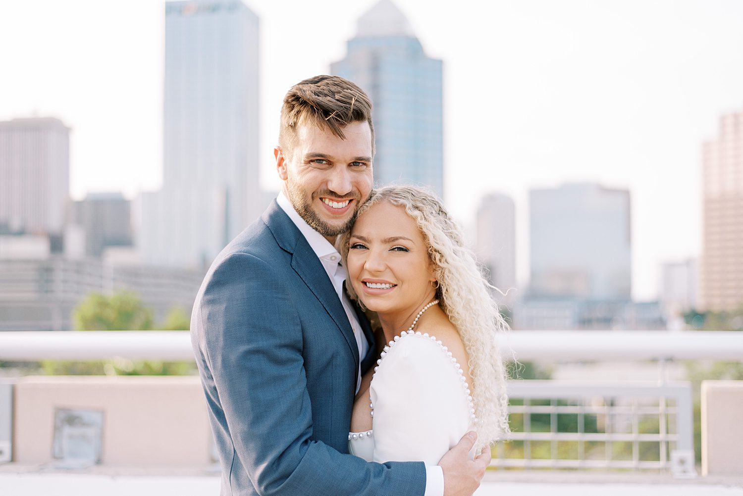 bride and groom hug together on downtown Tampa rooftop
