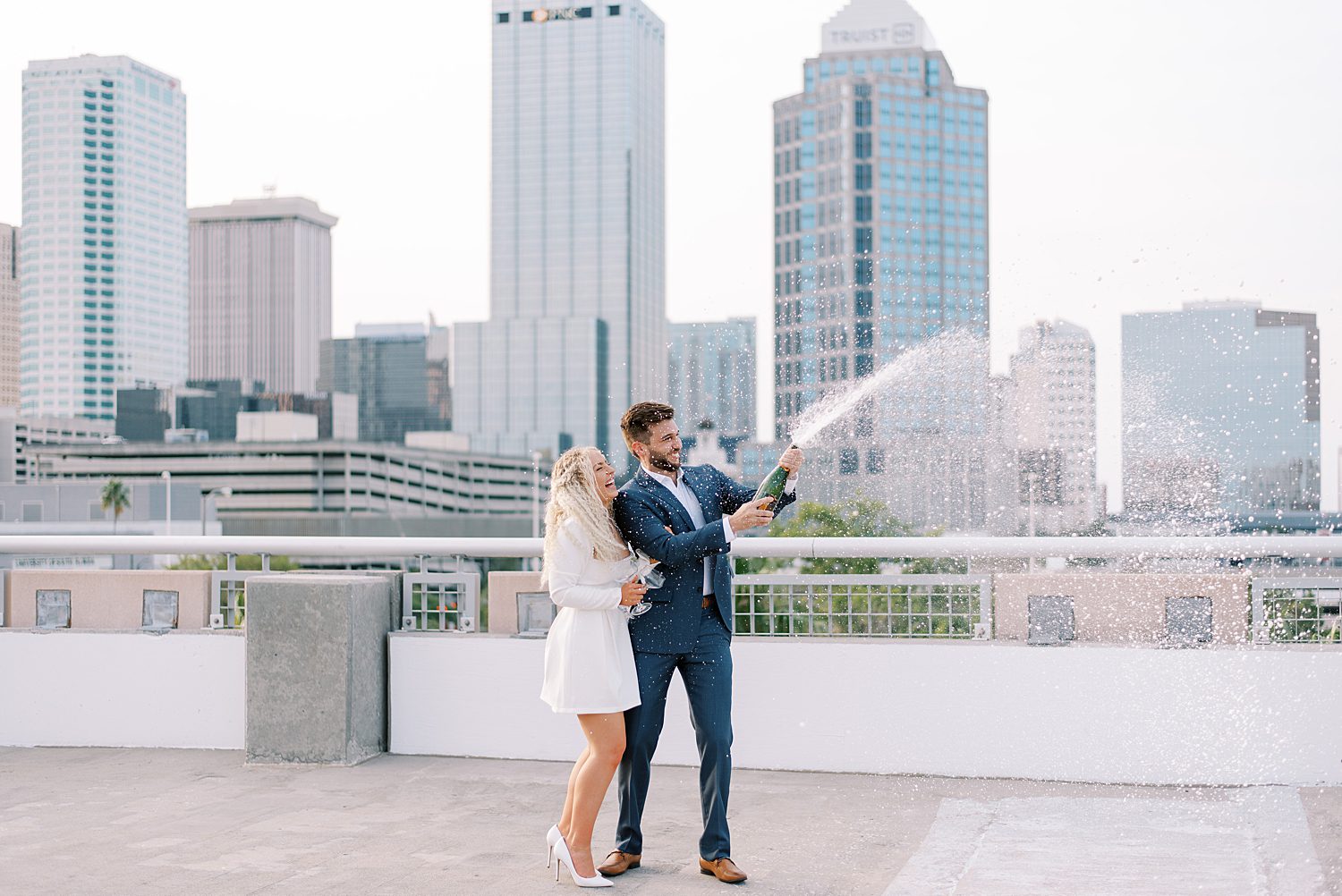 groom pops champagne bottle on downtown Tampa rooftop