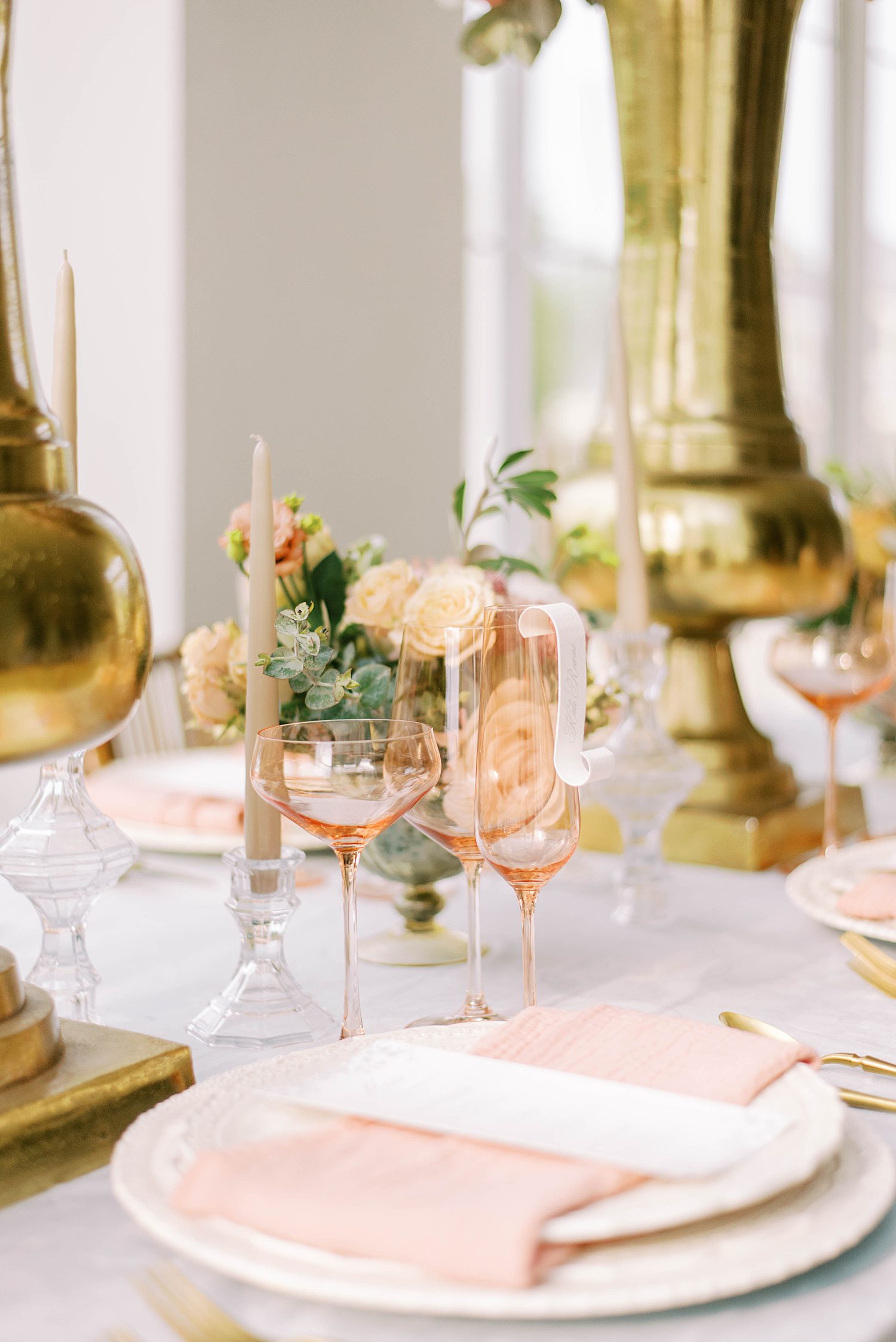 wedding reception place settings with blush glasses