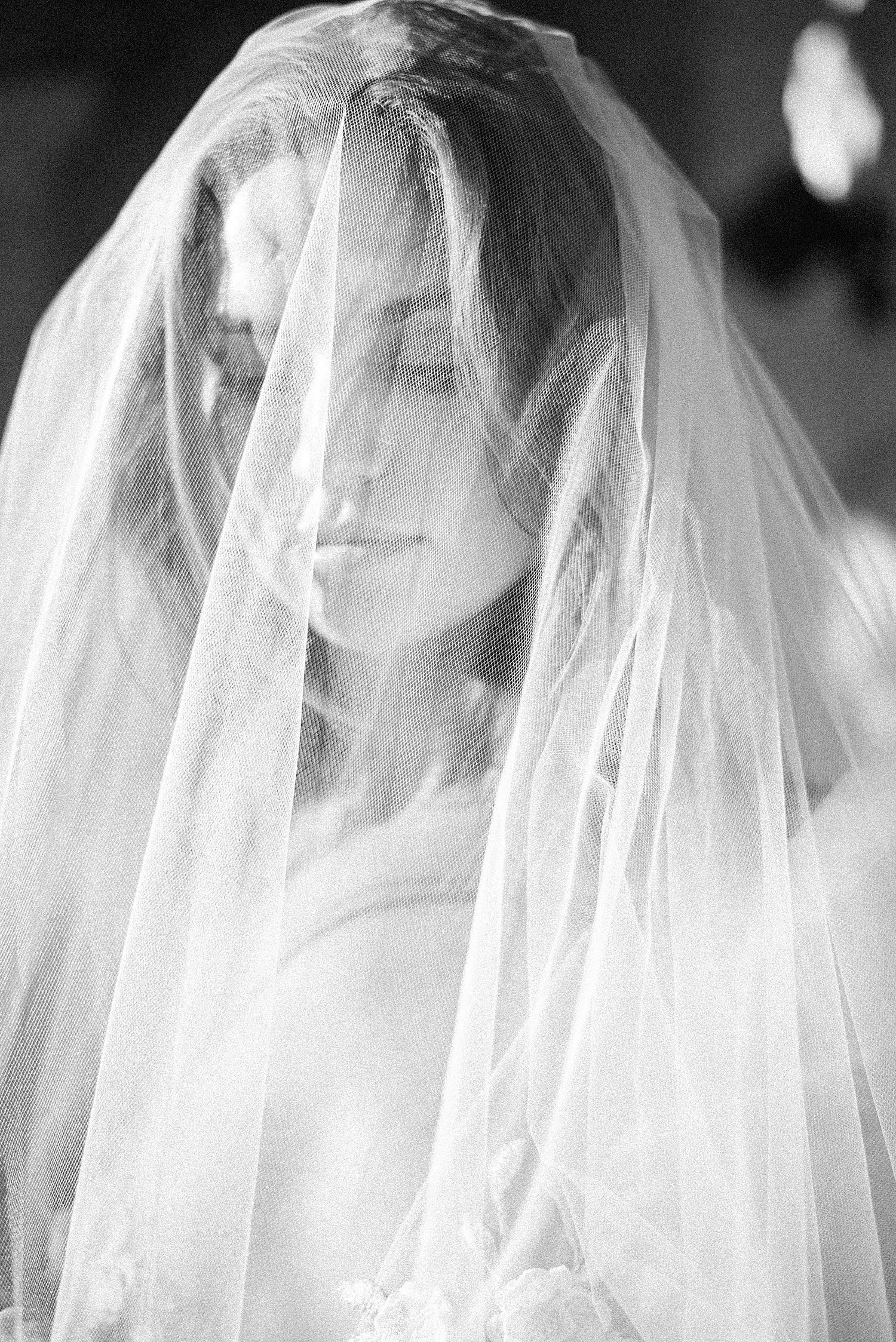 bride smirks under veil at Vizcaya Museum