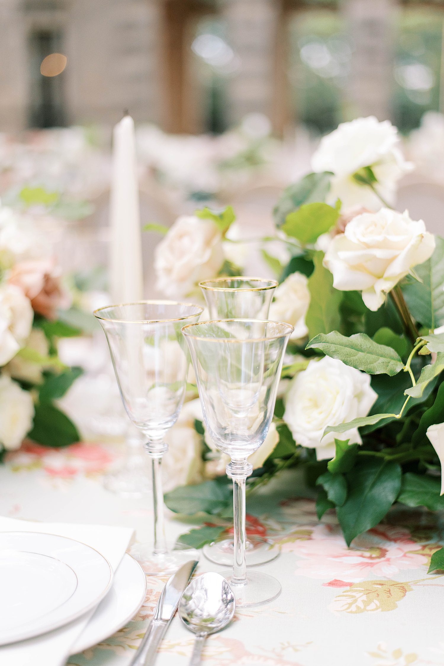 wedding reception with crystal glasses and ivory roses