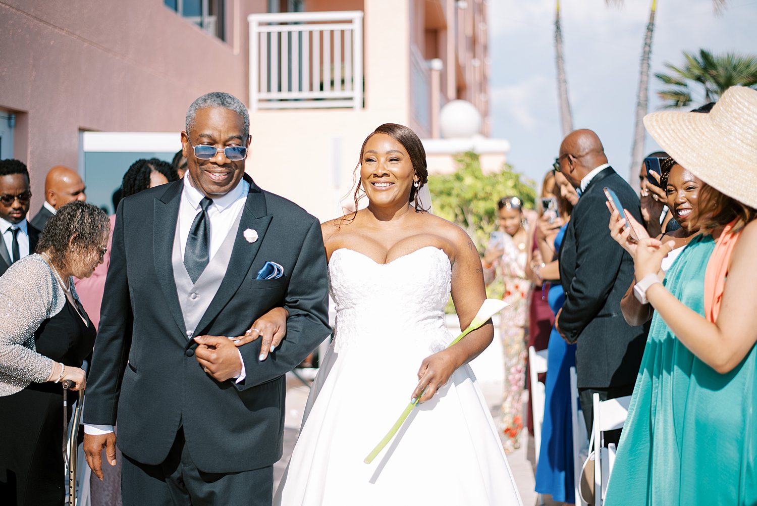 bride walks down aisle for wedding ceremony on Tampa hotel balcony