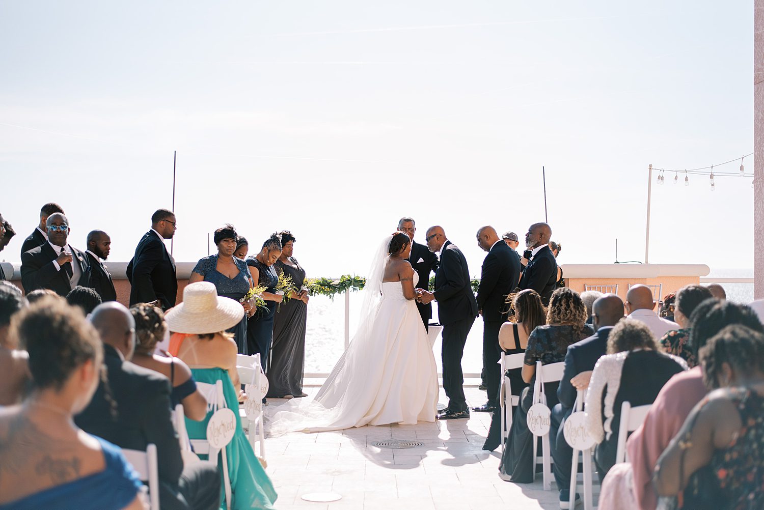 bride and groom lean heads together during wedding ceremony on Tampa hotel balcony