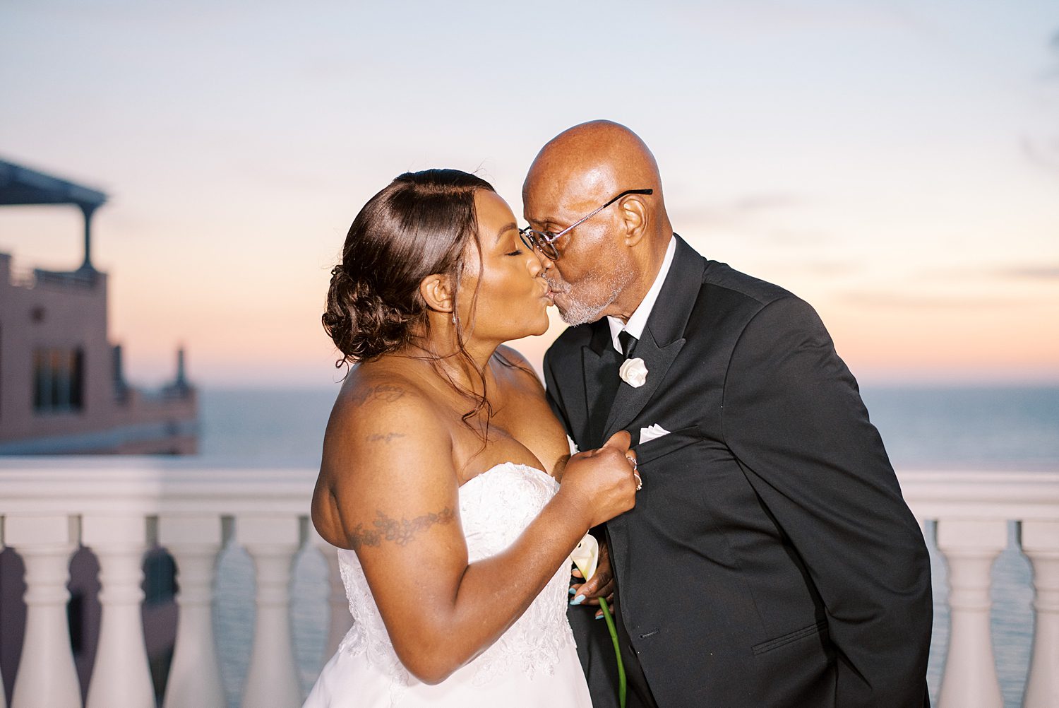 bride and groom kiss on patio at sunset at the Hyatt Clearwater