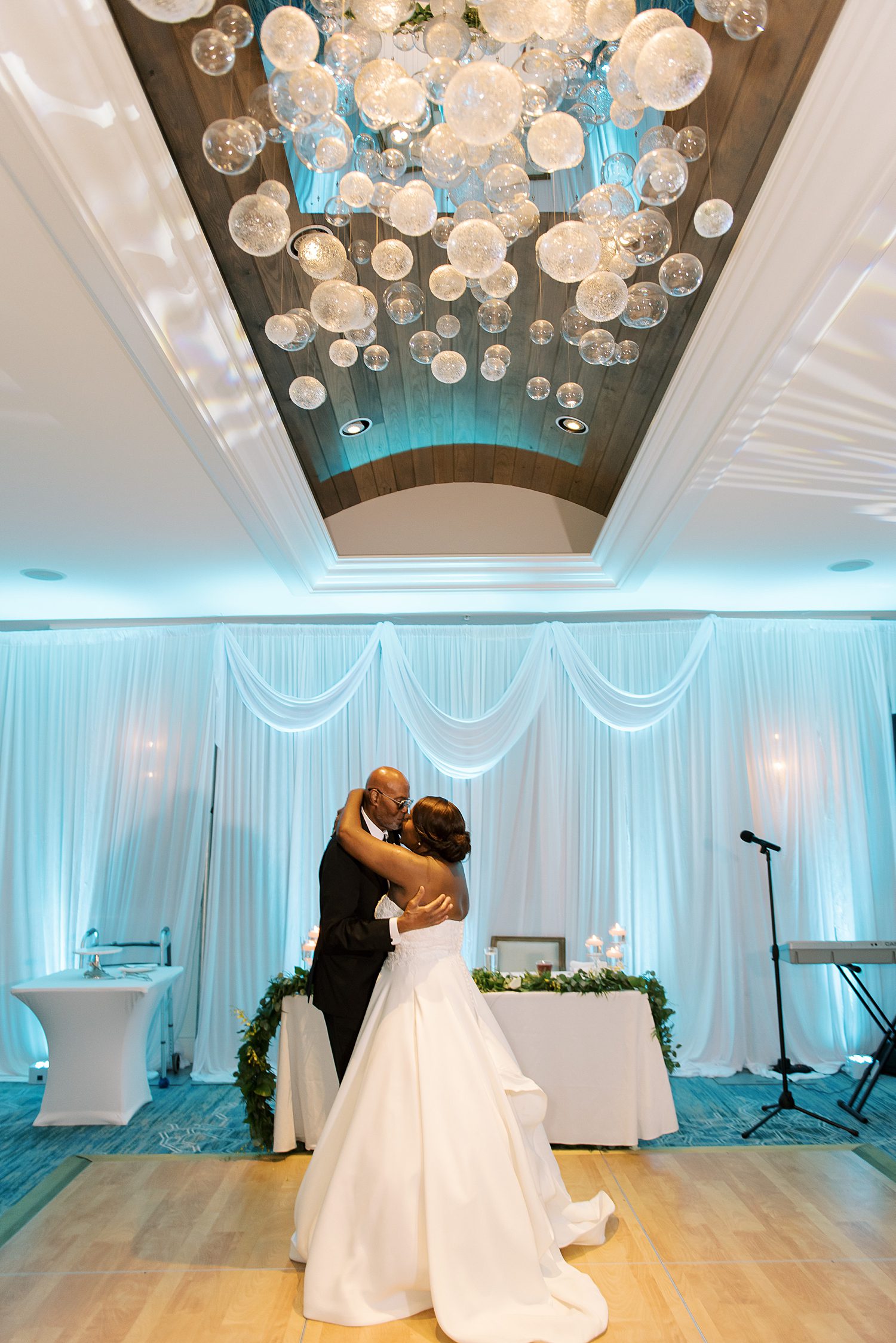 newlyweds dance under ballroom ceiling with white lights at the Hyatt Clearwater