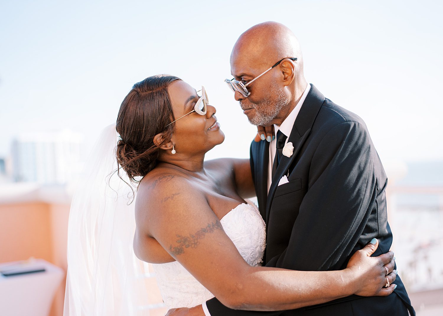 bride and groom hug on balcony at Hyatt Clearwater in Florida