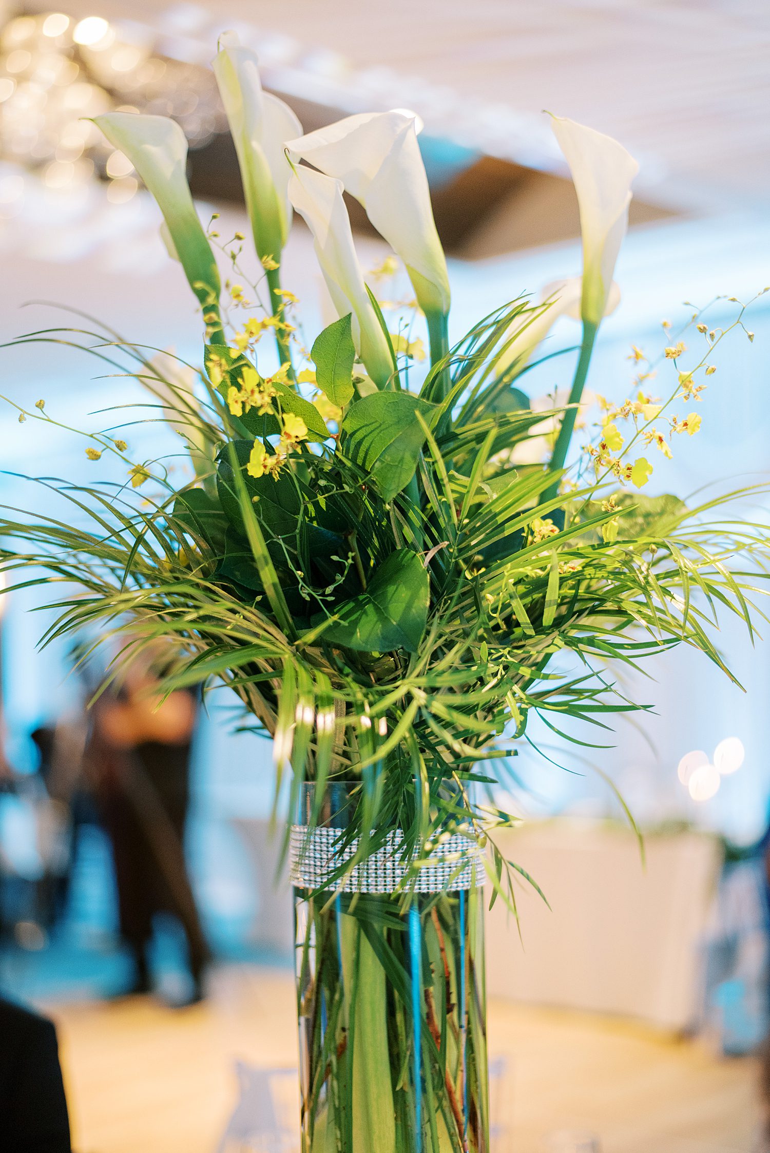 wedding reception florals with greenery, yellow accents and calla lilies 