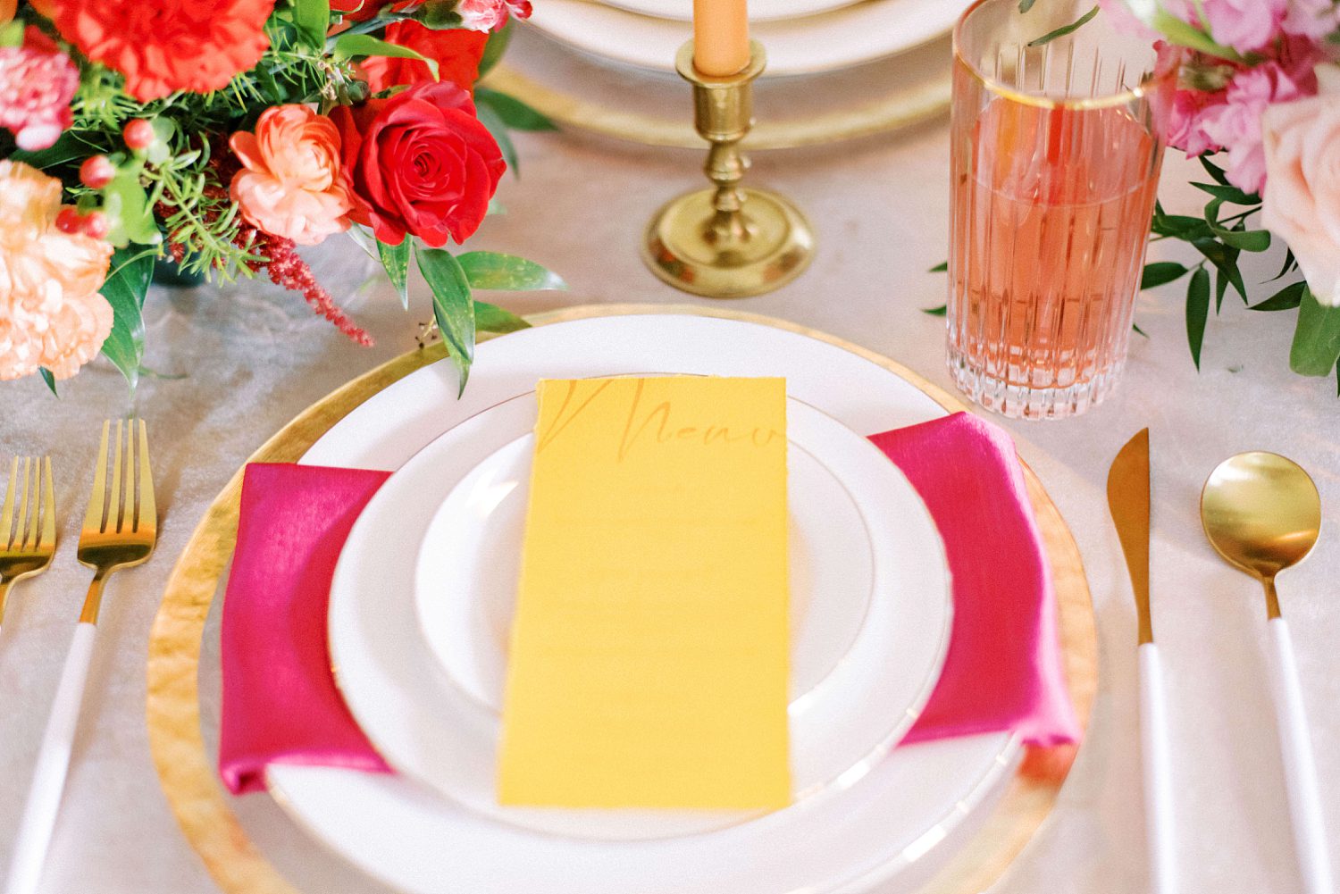 place setting with bright yellow menu card and pink napkins at The Orlo