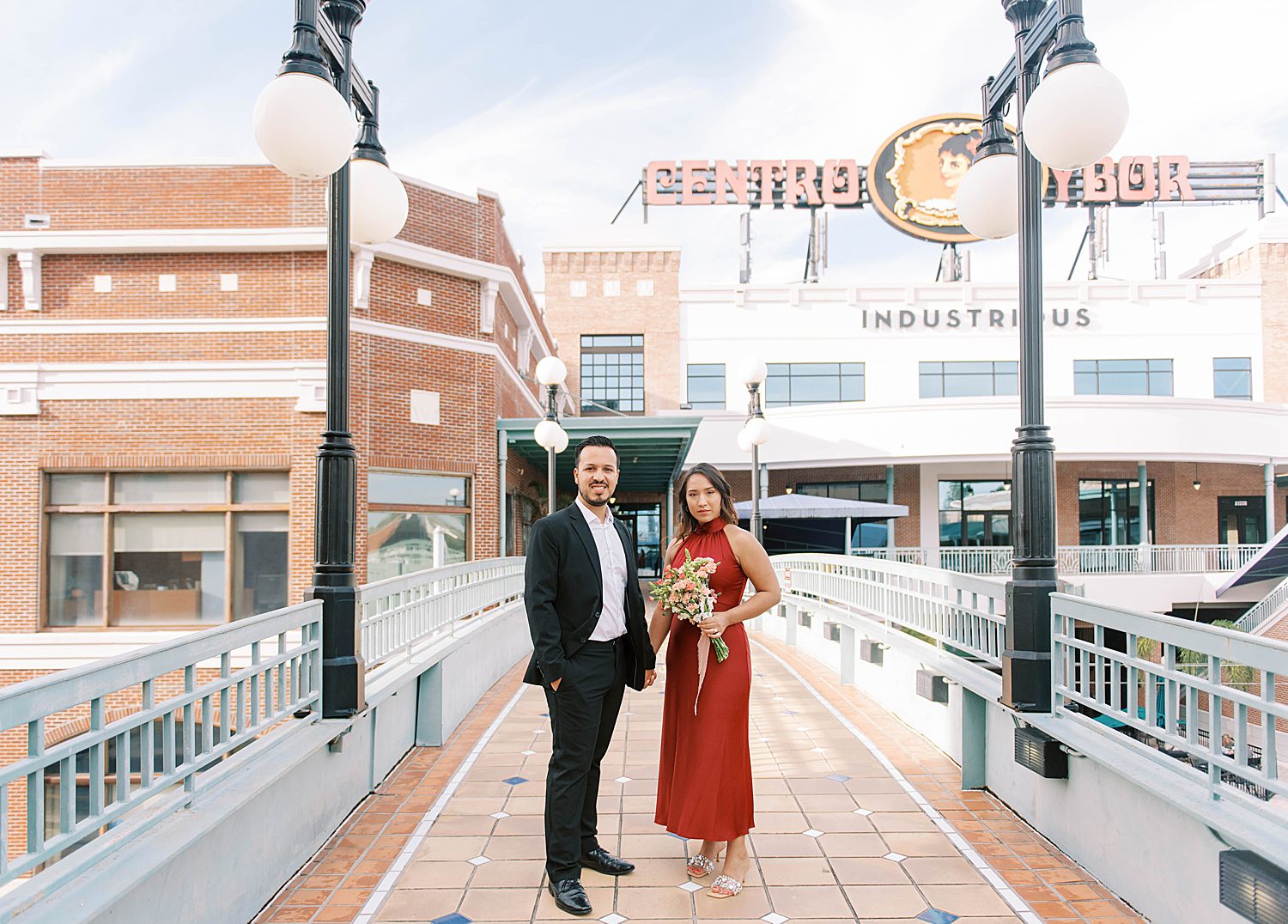 couple stands in front of shops in Ybor City
