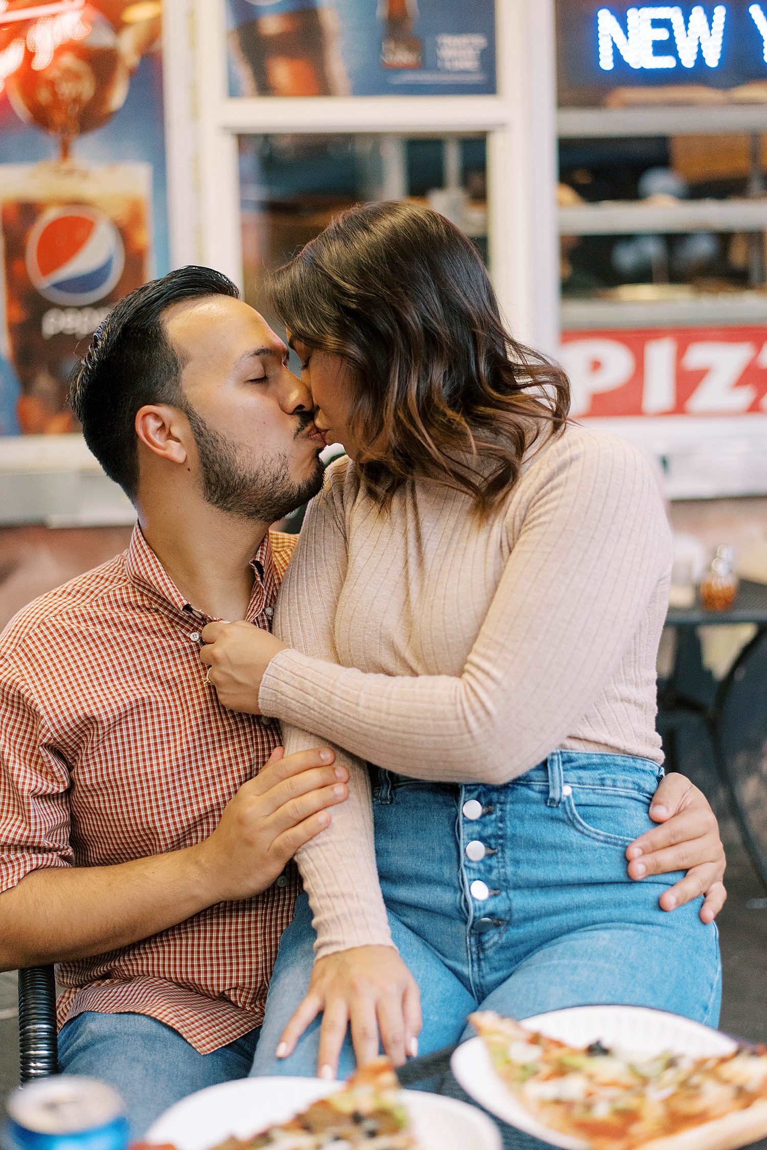 bride and groom kiss in Ybor City pizza shop