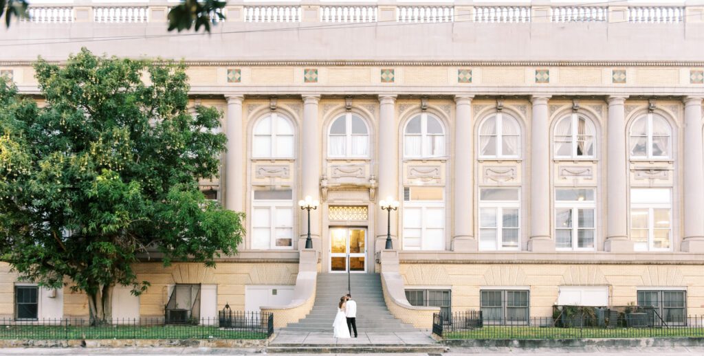 Centro asturiano de Tampa wedding portrait of bride and groom kissing with centro asturiano de Tampa in the background