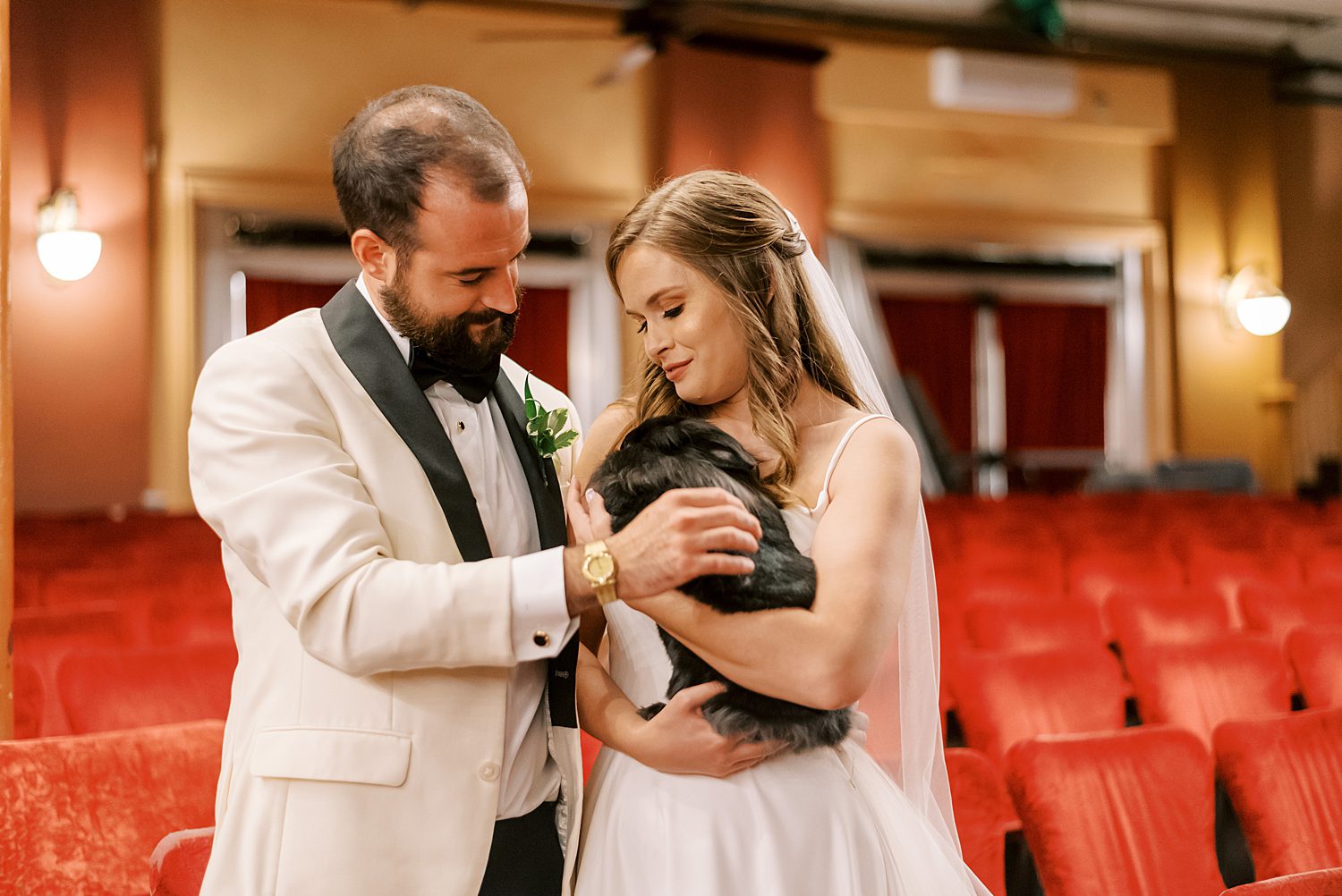 bride and groom stand together inside Centro Asturiano de Tampa with pet rabbit 