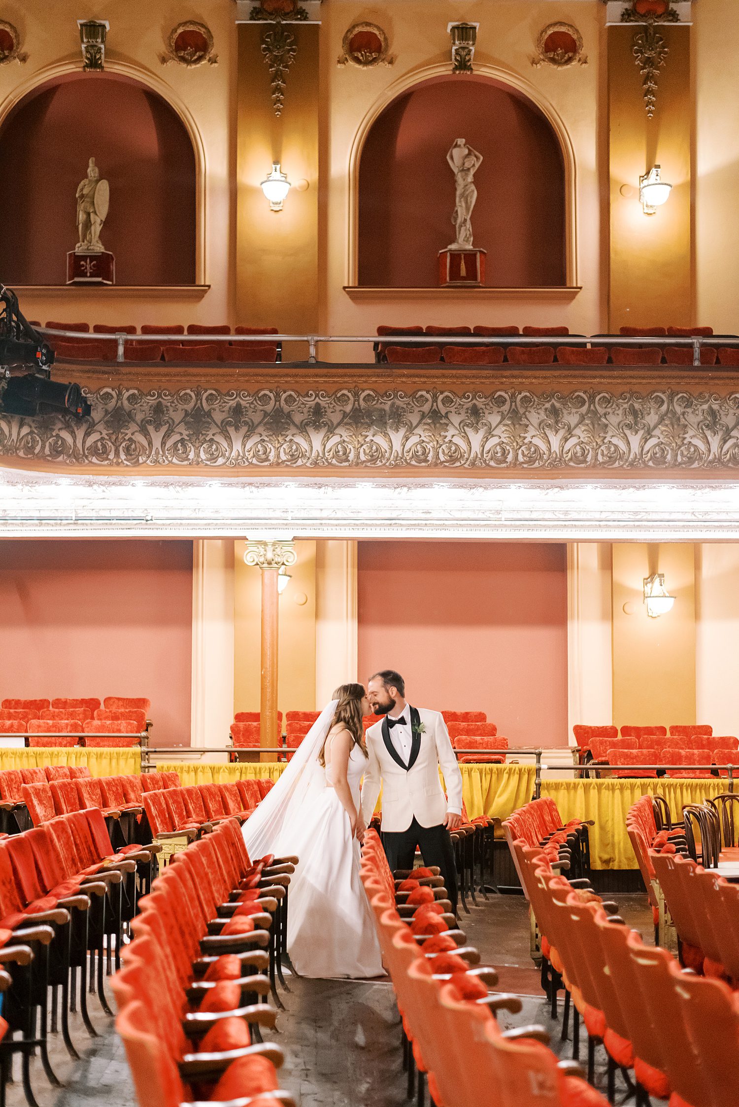 bride and groom kiss inside Centro Asturiano de Tampa