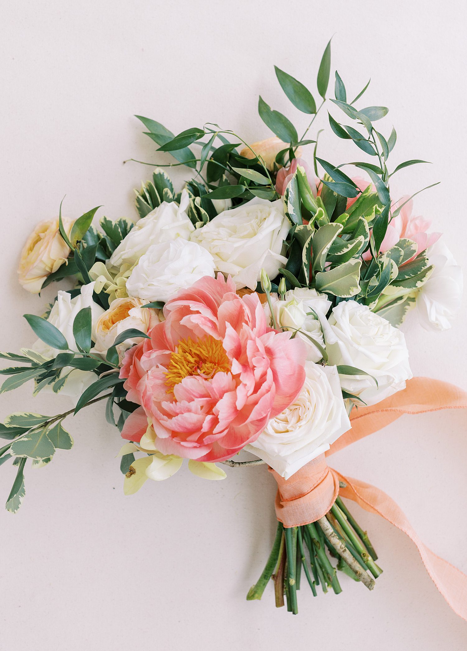 bride's bouquet of pink and white flowers with pink ribbon