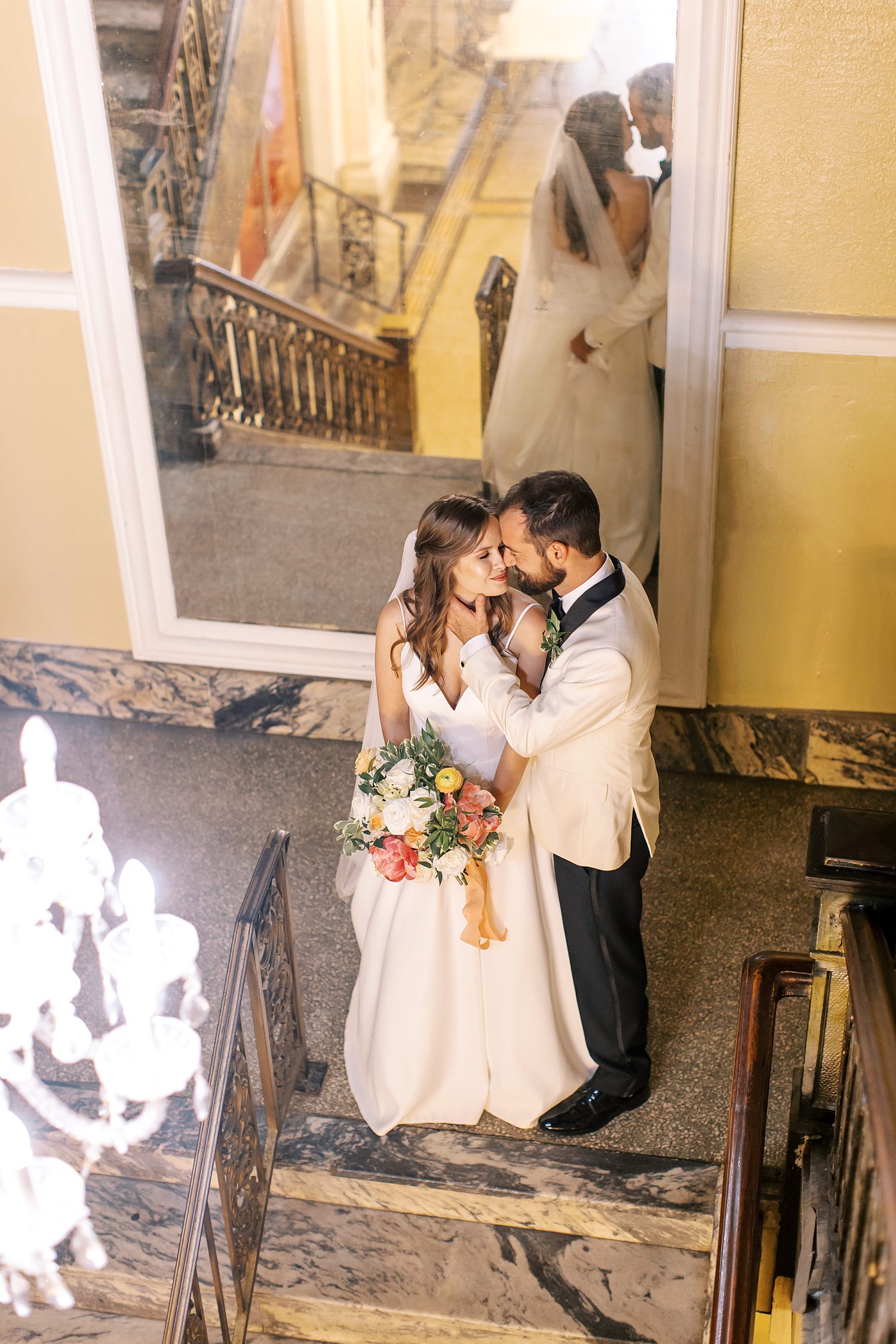 bride and groom hug near mirror inside Centro Asturiano de Tampa