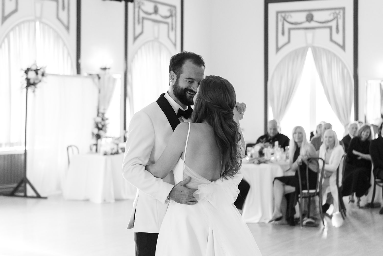 groom grins at bride during first dance inside the Centro Asturiano de Tampa