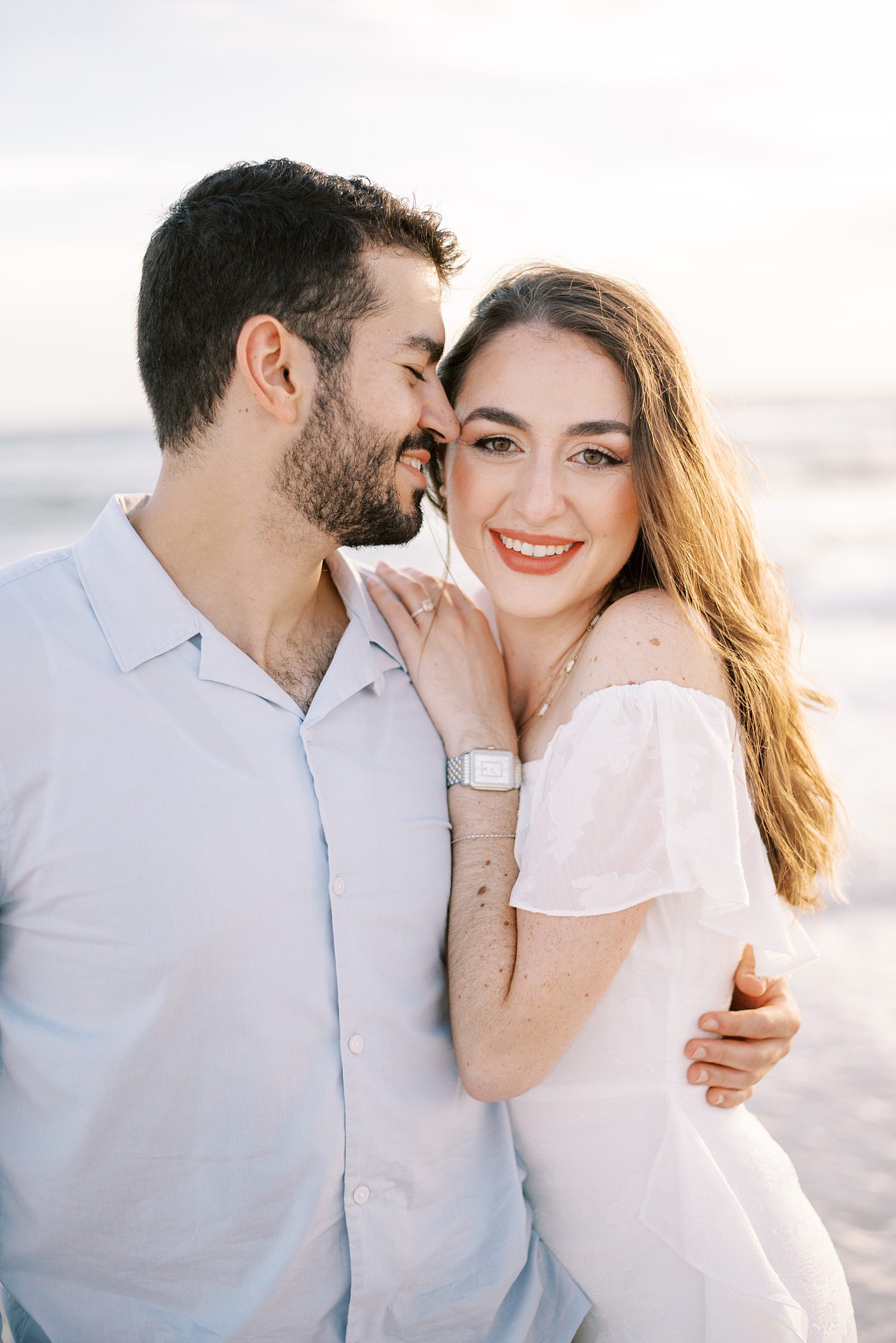 man hugs woman to him nuzzling his cheek in Tampa FL