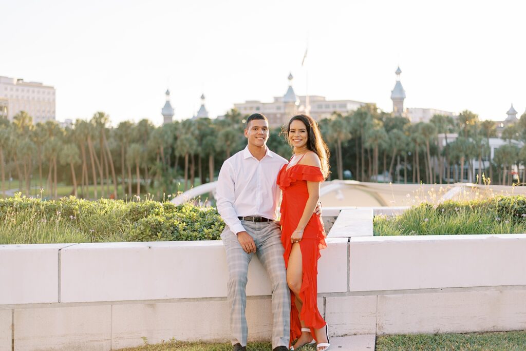engaged couple leans on wall during downtown Tampa engagement session