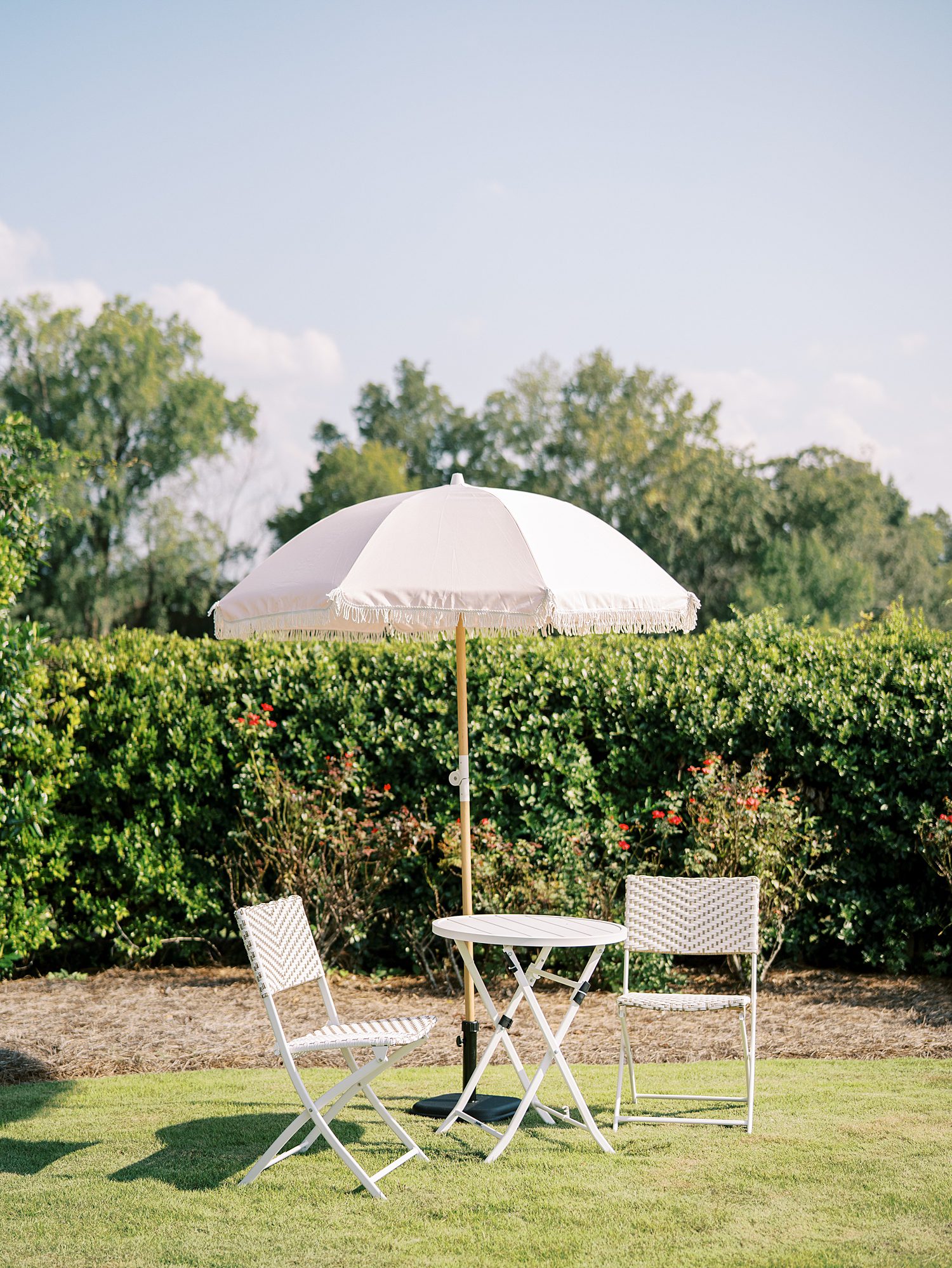 white table with chairs under umbrella at The Bibb Mill Event Center