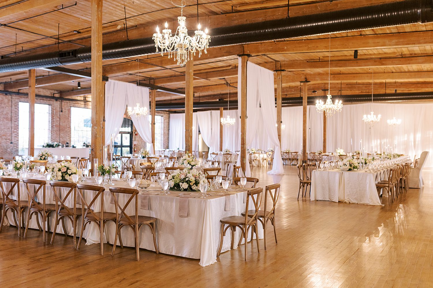 wedding reception with white and pink flowers and white linens at The Bibb Mill Event Center