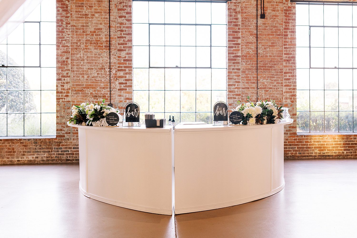 custom bar with black signs for The Bibb Mill Event Center wedding reception