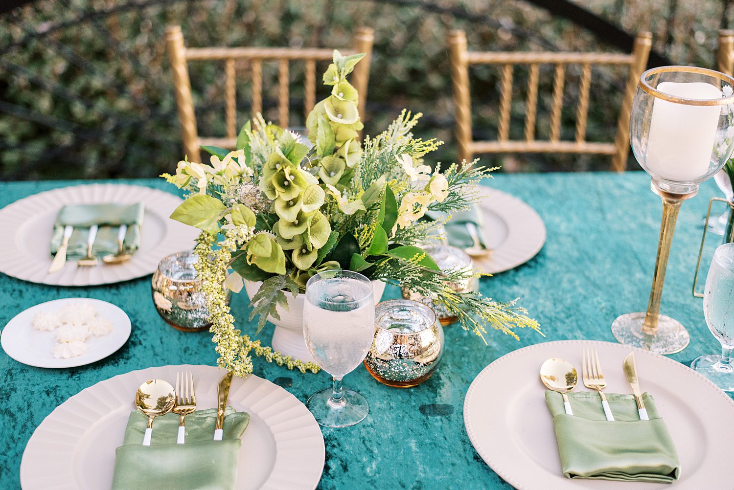 place setting on teal table cloth with mint napkins at The Bibb Mill Event Center