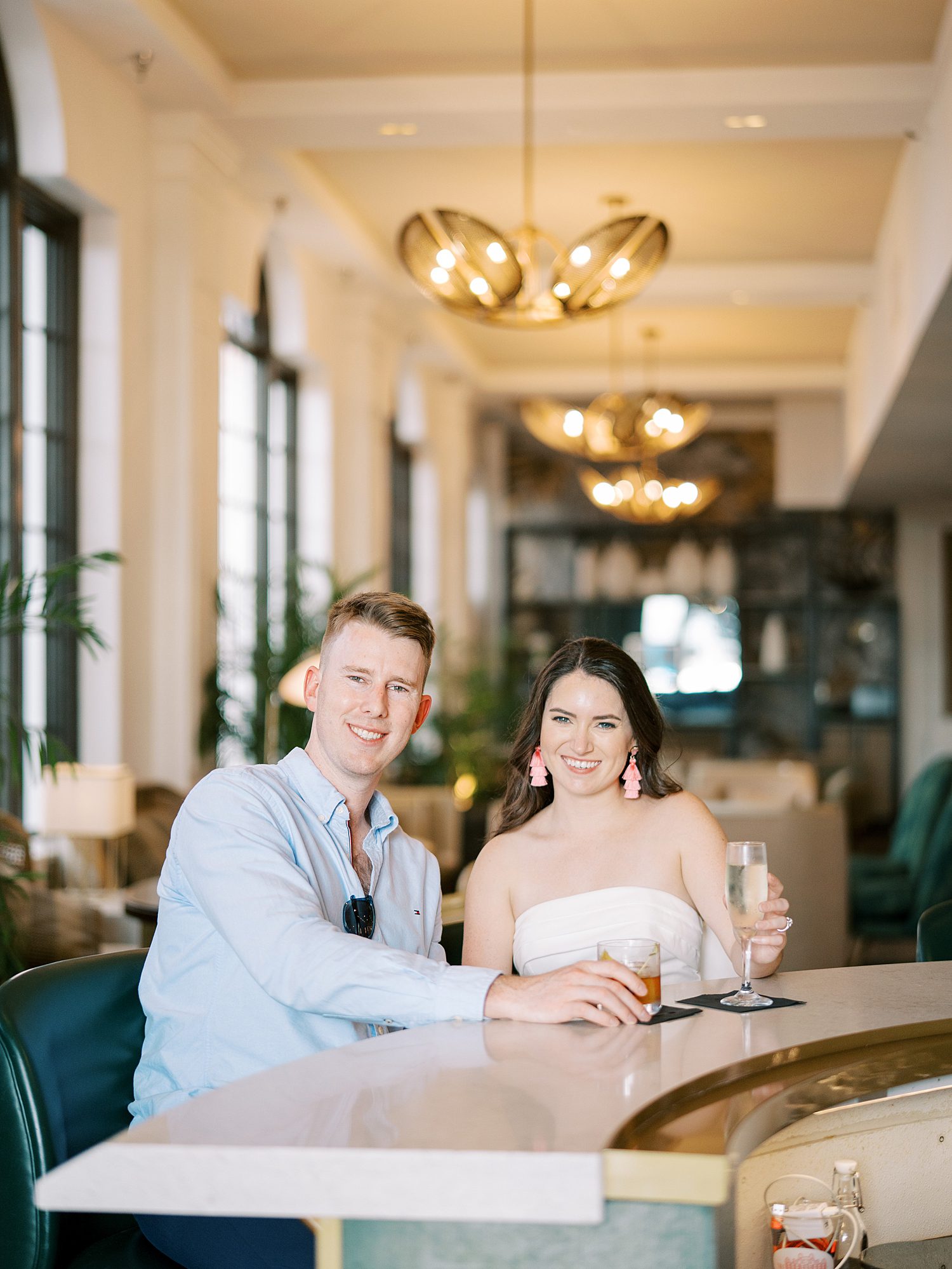 engaged couple sits inside restaurant during The Don Cesar Hotel engagement session