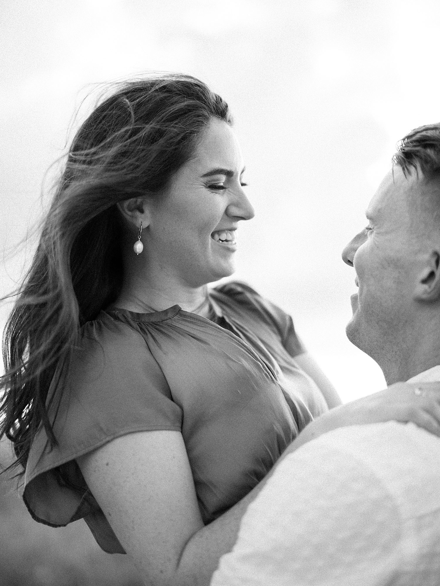 man lifts up fiancee smiling at her during Don Cesar Hotel engagement session