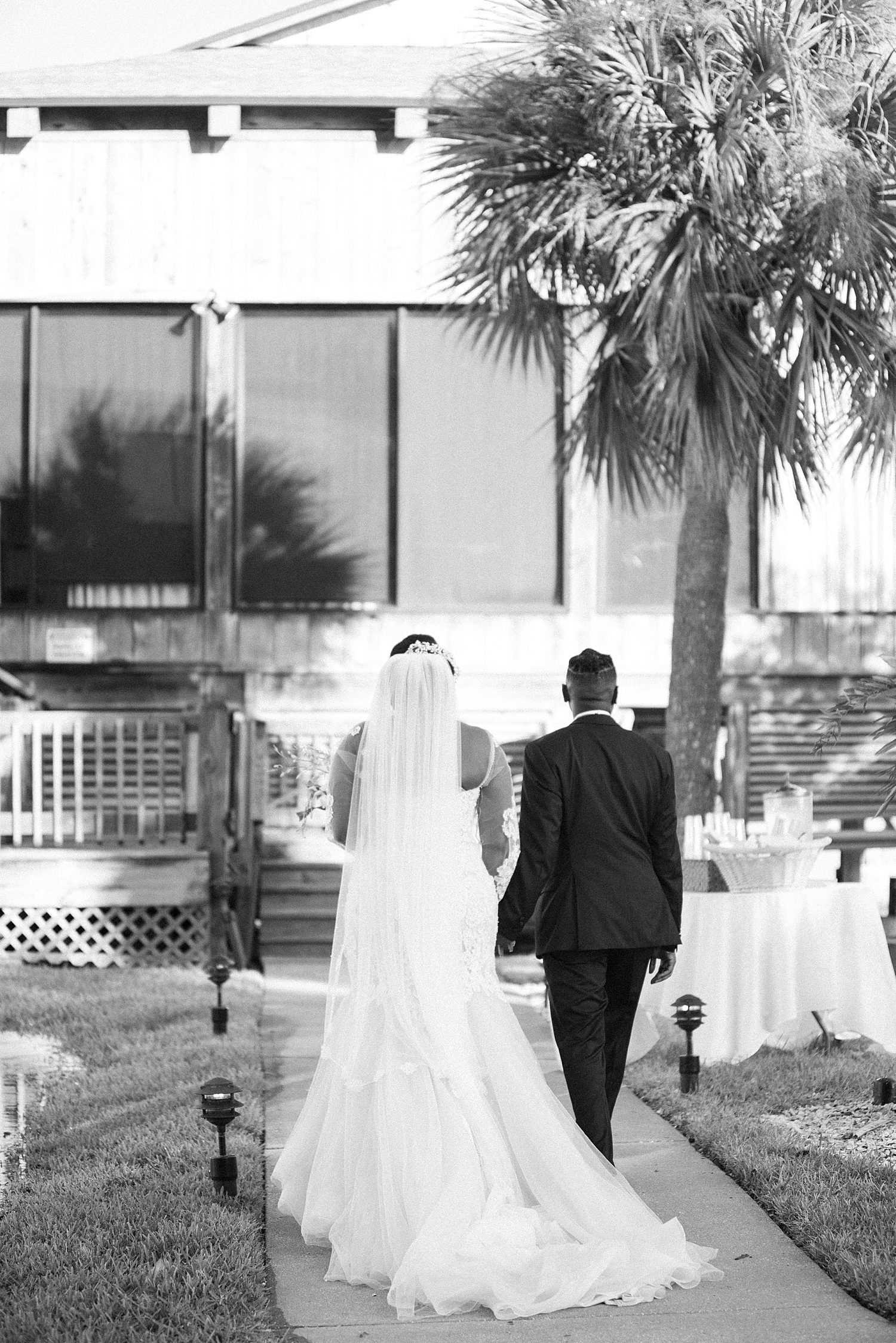 bride and groom walk towards The Rusty Pelican Tampa after ceremony 