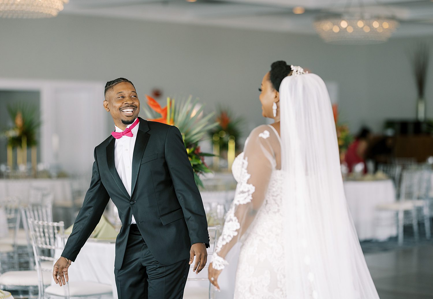 groom grins at bride during first look during Tampa FL wedding day