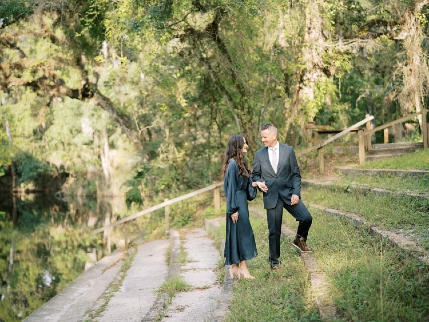 man leads woman up hill during Hillsborough River State Park engagement session