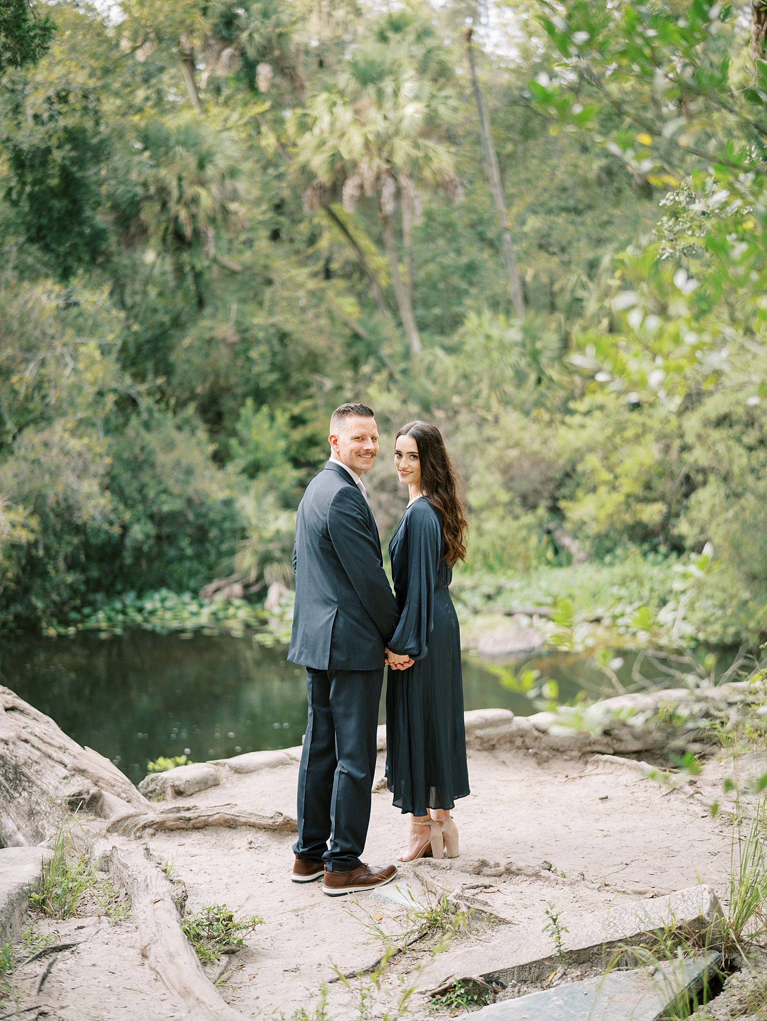 man and woman stand on path by river at Hillsborough River State Park