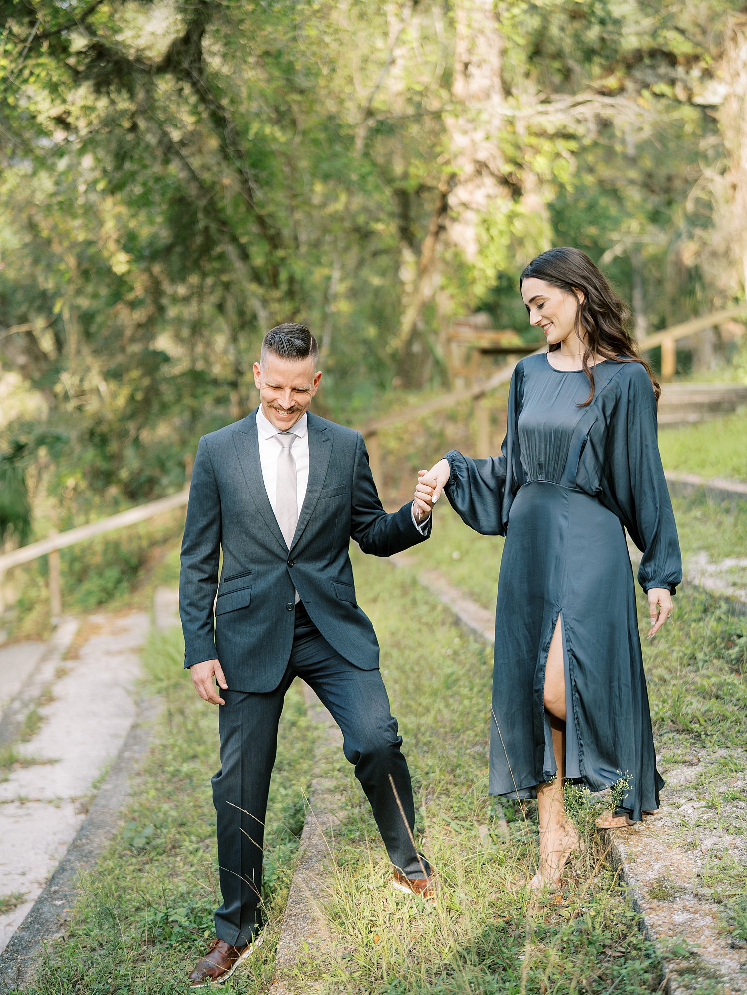 man leads woman down hill in Tampa FL at Hillsborough River State Park