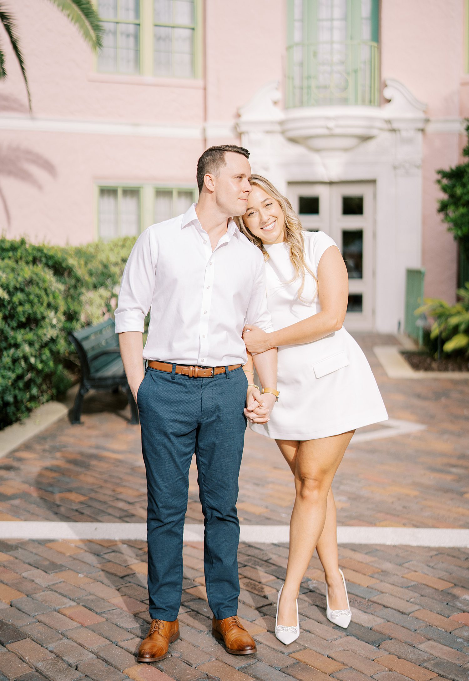 woman lays head on groom's shoulder during Tampa Museum of Fine Arts engagement session 