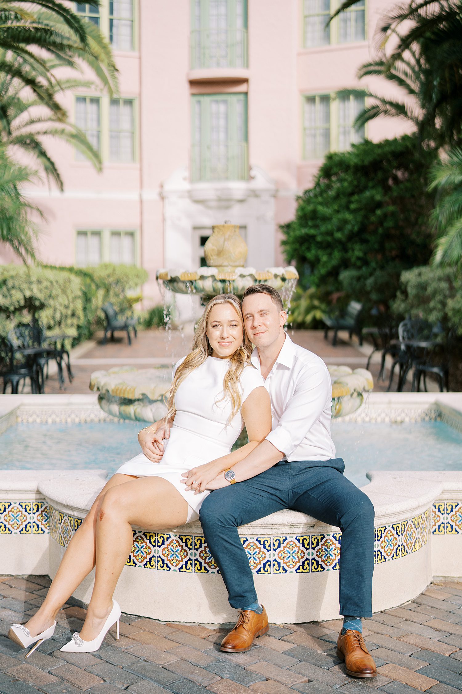 couple sits on fountain outside the Tampa Museum of Fine Arts