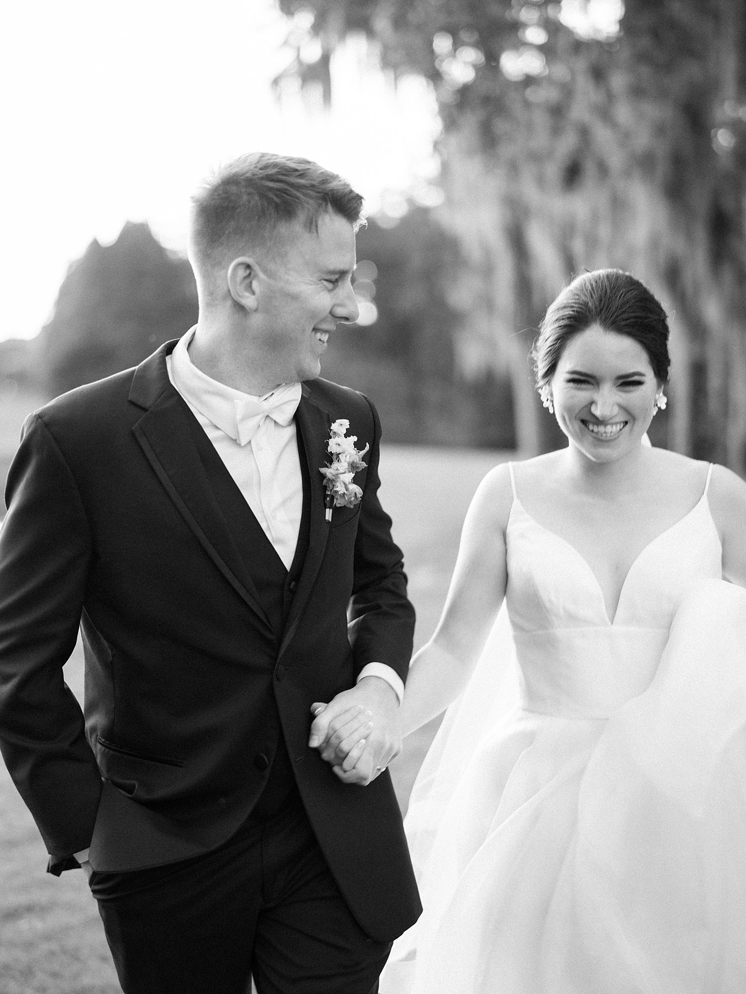 bride and groom hold hands walking through Tampa FL golf course 